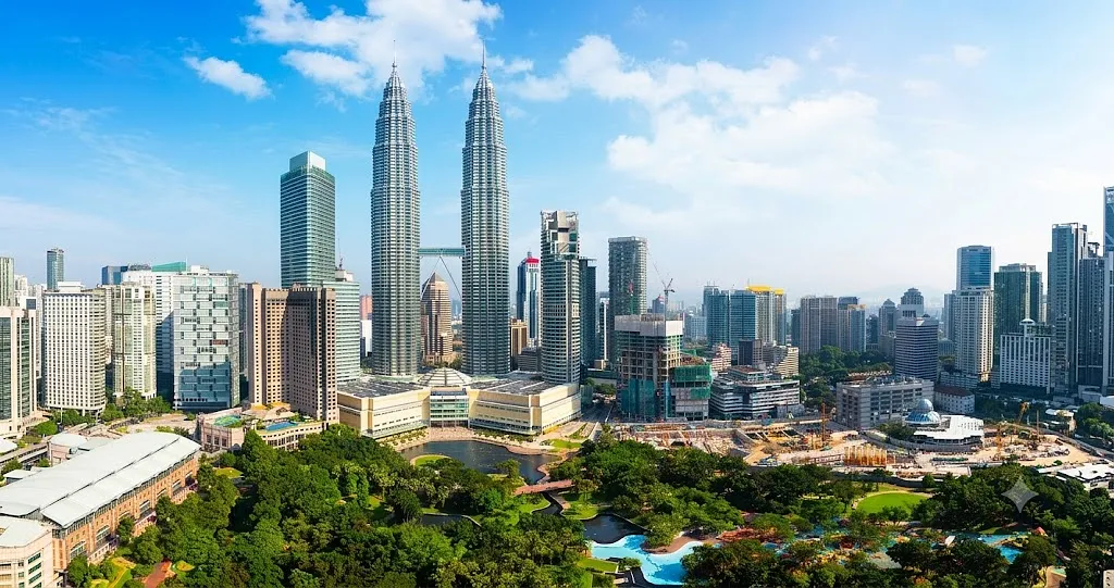 Aerial view of the Kuala Lumpur skyline in Malaysia, featuring the prominent Petronas Twin Towers.